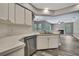 Open-concept kitchen view into living area with fireplace and lots of natural light at 11379 Flower Ave, Weeki Wachee, FL 34613