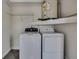 Laundry room with washer, dryer, shelving and water heater at 11379 Flower Ave, Weeki Wachee, FL 34613