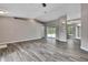 The home features an open floor plan with wood-look floors and direct access to the outdoor pool area at 11379 Flower Ave, Weeki Wachee, FL 34613