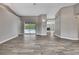 Open living space with wood-look floors, offering views of the pool through sliding glass doors at 11379 Flower Ave, Weeki Wachee, FL 34613