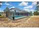 Gorgeous backyard with a sparkling screened pool and views of the peaceful neighborhood at 11379 Flower Ave, Weeki Wachee, FL 34613