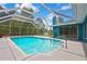 Backyard pool featuring an enclosed screen, clear water, and ample deck space for lounging and entertaining at 11379 Flower Ave, Weeki Wachee, FL 34613