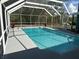 Spacious screened-in pool area with clear blue water, creating a serene and private retreat at 11379 Flower Ave, Weeki Wachee, FL 34613
