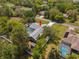 An elevated view of the home featuring a private pool, fenced yard, shed, and an inviting driveway at 1156 Battersea Ave, Spring Hill, FL 34609