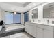 Bathroom featuring a dual vanity and a modern soaking tub at 1156 Battersea Ave, Spring Hill, FL 34609