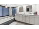 Bright bathroom featuring a dual vanity and a modern soaking tub at 1156 Battersea Ave, Spring Hill, FL 34609