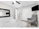 Serene bedroom with seating area, TV, and closet space, showcasing neutral tones at 1156 Battersea Ave, Spring Hill, FL 34609