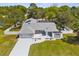 Stunning single-story home featuring a three-car garage, well-manicured lawn, and a secure fenced backyard at 1156 Battersea Ave, Spring Hill, FL 34609