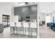 Open concept kitchen with seating, modern appliances, with backyard pool views at 1156 Battersea Ave, Spring Hill, FL 34609