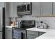 Modern kitchen with stainless steel appliances, granite countertops, and backsplash at 1156 Battersea Ave, Spring Hill, FL 34609