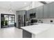 Contemporary kitchen with stainless steel appliances and backyard pool view at 1156 Battersea Ave, Spring Hill, FL 34609