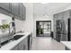 Kitchen featuring modern sink and backyard pool view at 1156 Battersea Ave, Spring Hill, FL 34609