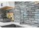 Close up of the kitchen sink and gray tiled backsplash at 1156 Battersea Ave, Spring Hill, FL 34609