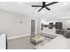 Bright living space with tile floors, open layout to kitchen, features a modern ceiling fan and neutral wall color at 1156 Battersea Ave, Spring Hill, FL 34609