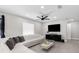 Bright living room with a white sectional sofa, modern decor, and lots of natural light at 1156 Battersea Ave, Spring Hill, FL 34609