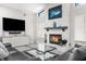 Bright living room with stone fireplace, TV, and comfortable gray sofas at 1156 Battersea Ave, Spring Hill, FL 34609