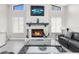 Living room featuring a stone fireplace, modern furnishings, and natural light at 1156 Battersea Ave, Spring Hill, FL 34609