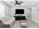 Bright living room features modern ceiling fan, TV, and modern entertainment center at 1156 Battersea Ave, Spring Hill, FL 34609