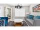 Inviting living room with a chandelier, plush seating, and bright natural light at 1156 Battersea Ave, Spring Hill, FL 34609