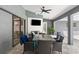 Covered patio with an outdoor dining area, television, and sliding glass doors to the interior at 1156 Battersea Ave, Spring Hill, FL 34609