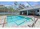 Beautiful backyard screened-in pool with a -safe spa, steps, and secure handrail at 1156 Battersea Ave, Spring Hill, FL 34609