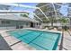 Relaxing screened-in pool area with lounge chairs and refreshing water at 1156 Battersea Ave, Spring Hill, FL 34609
