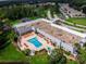 Aerial view of a community pool area with lounge chairs and surrounding green spaces at 12037 Boynton Ln, New Port Richey, FL 34654