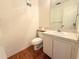 This bathroom features a classic vanity with a white sink and a clean, functional toilet at 12037 Boynton Ln, New Port Richey, FL 34654