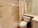 Accessible bathroom with a walk-in shower, safety bars, and white fixtures for convenience at 12037 Boynton Ln, New Port Richey, FL 34654