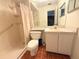 Well-lit bathroom featuring a walk-in shower, white fixtures, and essential amenities at 12037 Boynton Ln, New Port Richey, FL 34654