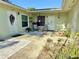 Inviting courtyard entrance with seating area, plants, and dual front doors at 12037 Boynton Ln, New Port Richey, FL 34654