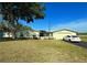 Charming single-story home with well-maintained lawn, a garage, and a car in the driveway at 12037 Boynton Ln, New Port Richey, FL 34654