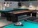 The community game room with billiard and shuffleboard tables under modern lighting at 12037 Boynton Ln, New Port Richey, FL 34654