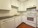 Bright kitchen with white cabinets, tiled floors, and appliances at 12037 Boynton Ln, New Port Richey, FL 34654