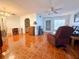 Spacious living room with tiled floors, featuring a recliner, desk, and TV at 12037 Boynton Ln, New Port Richey, FL 34654