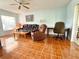 Cozy living room featuring tiled floors, ceiling fan, sofa and recliner set at 12037 Boynton Ln, New Port Richey, FL 34654