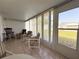 Cozy sunroom featuring tile flooring, comfortable seating, and ample natural light at 12037 Boynton Ln, New Port Richey, FL 34654