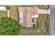 Aerial view of a brown roofed single Gathering home with a small outdoor patio and gray rectangular structure attached at 12087 Tallwood St, Spring Hill, FL 34608