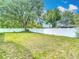 Expansive backyard with lush lawn and mature trees at 12087 Tallwood St, Spring Hill, FL 34608
