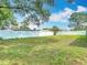 Expansive backyard featuring well-maintained lawn and privacy fence at 12087 Tallwood St, Spring Hill, FL 34608
