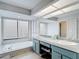 Bathroom features a dual sink vanity, soaking tub under a large window, and an expansive mirror at 12087 Tallwood St, Spring Hill, FL 34608