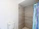 This bathroom features a standing shower with tile surround next to a toilet with a box on top at 12087 Tallwood St, Spring Hill, FL 34608