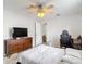 Comfortable bedroom with tile floors, ceiling fan, dresser and TV at 12087 Tallwood St, Spring Hill, FL 34608