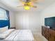 Comfortable bedroom featuring tile floors, a ceiling fan, and a TV on the dresser at 12087 Tallwood St, Spring Hill, FL 34608