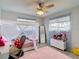 Well-lit bedroom with a cute canopy bed and pink accents at 12087 Tallwood St, Spring Hill, FL 34608