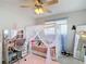 Well-lit bedroom with a cute canopy bed and pink accents at 12087 Tallwood St, Spring Hill, FL 34608