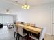 Bright dining area featuring a wooden table with six upholstered chairs and an elegant chandelier at 12087 Tallwood St, Spring Hill, FL 34608