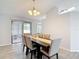 Inviting dining room with a wood table, six chairs, and sliding glass doors to the backyard at 12087 Tallwood St, Spring Hill, FL 34608
