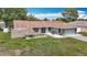 Charming single-story home featuring a well-manicured lawn and an attached two-car garage at 12087 Tallwood St, Spring Hill, FL 34608