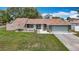 Charming single-story home featuring a well-manicured lawn and an attached two-car garage at 12087 Tallwood St, Spring Hill, FL 34608